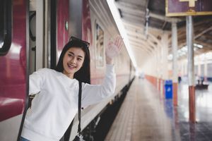 Women are happy while traveling train station tourism concept