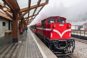 Alishan’s red forest railway train stopping on platform at Zhaoping Station, Chiayi, Taiwan