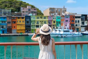 woman sightseeing at the colorful Zhengbin Fishing Port, Keelung, Taiwan