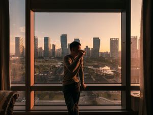 Man in a hotel by the window.